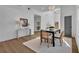 Bright dining room with modern table and chairs, hardwood floors, and stylish light fixture at 1565 Pineview Sw Ter, Atlanta, GA 30311