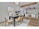 Bright dining area with a black table, natural light, and hardwood floors at 1565 Pineview Terrace Sw, Atlanta, GA 30311