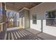 Covered porch with wooden flooring and modern railings at 1565 Pineview Terrace Sw, Atlanta, GA 30311