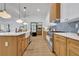 Modern kitchen with light wood cabinets, quartz countertops, and stainless steel appliances at 1565 Pineview Terrace Sw, Atlanta, GA 30311