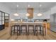 Modern kitchen with an eat-in island, stylish pendant lights, and light wood cabinets at 1565 Pineview Terrace Sw, Atlanta, GA 30311