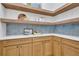 Bright pantry with light wood cabinets, open shelving, and blue tile backsplash at 1565 Pineview Terrace Sw, Atlanta, GA 30311