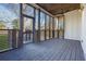 Spacious screened porch with dark wood flooring and access to backyard at 1565 Pineview Terrace Sw, Atlanta, GA 30311