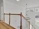 Elegant staircase with light wood railing and a large chandelier at 1565 Pineview Terrace Sw, Atlanta, GA 30311