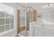 Shower with glass door in a bathroom full of natural light at 2428 Bridlewood Se Dr # 24, Atlanta, GA 30339