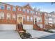 Three-story townhome with brick exterior, attached garage, and landscaping at 2428 Bridlewood Se Dr # 24, Atlanta, GA 30339