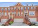 Charming brick townhome with attached garages, stairways leading to entry, and detailed architectural features at 2428 Bridlewood Se Dr # 24, Atlanta, GA 30339