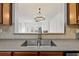 Kitchen features a double sink and view into the living room at 2428 Bridlewood Se Dr # 24, Atlanta, GA 30339