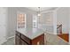 Kitchen island with cabinet storage, white chairs, and view to the staircase and breakfast room at 2428 Bridlewood Se Dr # 24, Atlanta, GA 30339