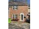 Brick townhouse with shutters, a door, and small front yard at 306 Flagstone Way # 306, Austell, GA 30168