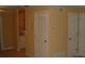 Hallway with doors and neutral colored walls at 306 Flagstone Way # 306, Austell, GA 30168