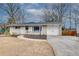 Ranch style home with a white garage door and manicured lawn at 3935 Admiral Dr, Chamblee, GA 30341