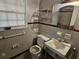 Bathroom with tiled walls, toilet and sink at 425 Hilderbrand Dr, Sandy Springs, GA 30328