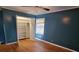 Bedroom with hardwood floors, open closet, and teal walls at 425 Hilderbrand Dr, Sandy Springs, GA 30328