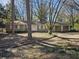 Ranch style home with attached two-car garage, and mature trees in the yard at 425 Hilderbrand Dr, Sandy Springs, GA 30328