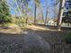 Landscaped yard with a walkway leading to a charming house at 425 Hilderbrand Dr, Sandy Springs, GA 30328