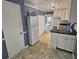 White kitchen cabinets, black countertops, and a view into the dining area at 425 Hilderbrand Dr, Sandy Springs, GA 30328