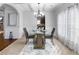 Elegant dining room with a glass table, chandelier, and neutral decor at 502 Starling View Cir, Grayson, GA 30017