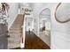 Bright foyer with hardwood floors, staircase, and view into dining room at 502 Starling View Cir, Grayson, GA 30017