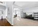 Living room with carpet, TV stand, and view to dining area at 502 Starling View Cir, Grayson, GA 30017