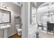 Powder room with pedestal sink, toilet, and shelving at 502 Starling View Cir, Grayson, GA 30017