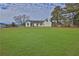 Large grassy backyard with a view of the house's back at 6460 Dove Dr, Loganville, GA 30052