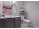 Small bathroom with a toilet, sink, and shower at 6460 Dove Dr, Loganville, GA 30052