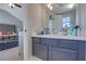 Bathroom with vanity, medicine cabinet, and view into bedroom at 6460 Dove Dr, Loganville, GA 30052