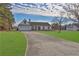 Front view of a single-story house with a long driveway at 6460 Dove Dr, Loganville, GA 30052