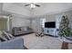 Living room with hardwood floors, Christmas tree and cozy seating at 6460 Dove Dr, Loganville, GA 30052