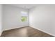 Simple bedroom with hardwood floors and window at 7260 Crestside Dr, Austell, GA 30168