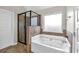 Bathroom with soaking tub and walk-in shower at 845 Nevis Way, Mcdonough, GA 30253
