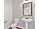 Simple bathroom with pedestal sink and toilet at 845 Nevis Way, Mcdonough, GA 30253