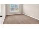 Bright bedroom featuring neutral walls and plush carpeting at 845 Nevis Way, Mcdonough, GA 30253