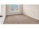 Well-lit bedroom featuring neutral walls and carpet flooring at 845 Nevis Way, Mcdonough, GA 30253