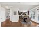 Open concept dining area with kitchen view and hardwood floors at 845 Nevis Way, Mcdonough, GA 30253