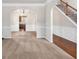 Spacious dining room with neutral carpeting and elegant chandelier at 845 Nevis Way, Mcdonough, GA 30253