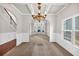 Spacious dining room with neutral carpeting and elegant chandelier at 845 Nevis Way, Mcdonough, GA 30253