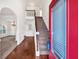 Bright entryway with hardwood floors, staircase, and views into the living room at 845 Nevis Way, Mcdonough, GA 30253