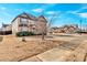 Two-story brick home with a red door and landscaping at 845 Nevis Way, Mcdonough, GA 30253