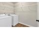 Laundry room with washer, dryer, and ample shelving at 845 Nevis Way, Mcdonough, GA 30253