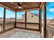 Relaxing screened porch with wooden deck and ceiling fan at 845 Nevis Way, Mcdonough, GA 30253