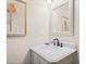 Small bathroom with marble vanity and decorative mirror at 103 Cardinal Se Rd, White, GA 30184