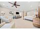 Main bedroom with sitting area and a ceiling fan at 103 Cardinal Se Rd, White, GA 30184