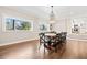 Bright dining room with hardwood floors, large windows, and farmhouse table at 103 Cardinal Se Rd, White, GA 30184