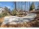 Curving driveway surrounded by lush trees at 103 Cardinal Se Rd, White, GA 30184