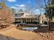 Gray house with wrap around porch and stone retaining wall at 103 Cardinal Se Rd, White, GA 30184