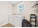 Laundry room with washer, dryer, and ample storage at 103 Cardinal Se Rd, White, GA 30184