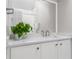 Bathroom featuring bright quartz countertops, white cabinets, modern fixtures, and a large mirror at 685 Greystone Ne Park, Atlanta, GA 30324