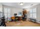 Bright home office featuring built-in shelves, modern furniture, and natural light from two large windows at 685 Greystone Ne Park, Atlanta, GA 30324